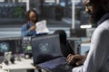 Data center admin using AI visualization tools on laptop to identify malfunction Royalty Free Stock Photo