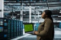 Data center admin using green screen laptop to automate anomaly detection Royalty Free Stock Photo
