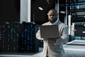Data center computer scientist using laptop to protect servers Royalty Free Stock Photo
