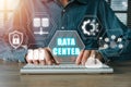 Person hand typing on keyboard computer with data center icon on virtual screen Royalty Free Stock Photo