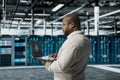 Data center engineer using artificial intelligence automation tools on laptop Royalty Free Stock Photo