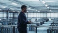Data Center Engineer Using Laptop Computer. Server Farm Cloud Computing Specialist Facility with Royalty Free Stock Photo