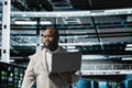 Data center engineer using laptop to troubleshoot backend operations Royalty Free Stock Photo