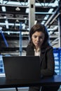 Data center female engineer using laptop to review equipment diagnostics Royalty Free Stock Photo