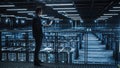 Data Center Male Administrator Using Laptop Computer. Cloud Computing Facility Maintenance Specialis Royalty Free Stock Photo