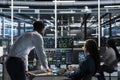 Data center manager supervises engineer using AI visual programming Royalty Free Stock Photo