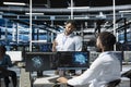 Data center manager supervising work done by engineer using deep learning tech Royalty Free Stock Photo
