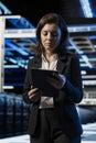 Data center software developer using tablet to install and configure equipment Royalty Free Stock Photo