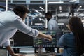 Data center supervisor overseeing admin using PC to visualize AI node trees Royalty Free Stock Photo