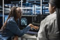 Data center team leader oversees engineer using AI visualization tools Royalty Free Stock Photo