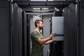 Data center technician installing and maintaining servers in a modern server rack Royalty Free Stock Photo