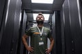 Data center technician inspecting server racks in a modern data center with confident professional stance Royalty Free Stock Photo