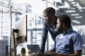Data engineering IT staff members at PC desk doing machine learning