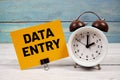 Data Entry text written on paper card with alarm clock on wooden background Royalty Free Stock Photo