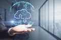 Data and information exchange concept with digital round sphere with cloud sign and arrows inside on man hand at abstract office Royalty Free Stock Photo