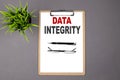 DATA INTEGRITY on the brown clipboard on the grey background. Business concept