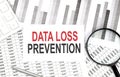 DATA LOSS PREVENTION text on paper with calculator,pen on graph background Royalty Free Stock Photo