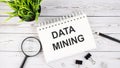 DATA MINING text concept write on notebook with office tools on wooden background Royalty Free Stock Photo
