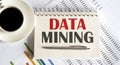 Data mining text written on a notebook with pen and chart Royalty Free Stock Photo