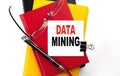 DATA MINING text written on a sticky on colorful notebooks