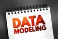 Data modeling - process of creating a data model for an information system by applying certain formal techniques, text on notepad