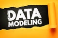 Data modeling text shown on torn paper symbolizing analytics, structure, information processing, and system design, perfect for Royalty Free Stock Photo