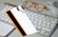 Data phishing, big hook with credit card on computer keyboard and workplace blurred in the background Royalty Free Stock Photo