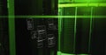 Data processing image over green-lit server room with floating code screens Royalty Free Stock Photo
