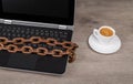 Data protection. Rusty chain. Laptop keyboard detail. Coffee Royalty Free Stock Photo