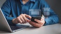 Data retrieval technology improves search engine optimization (SEO). Man uses both mobile phone and laptop to search for