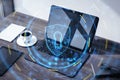 Data safety and cyber security concept with digital graphic glowing blue shield symbol with keyhole on office table with laptop