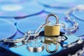 Data security, information protection and personal information defense. Padlock on hard drive disk at CD disk background. Concept Royalty Free Stock Photo