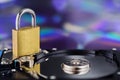 Data security, information protection and personal information defense. Padlock on hard drive disk at CD disk background. Concept Royalty Free Stock Photo