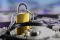 Data security, information protection and personal information defense. Padlock on hard drive disk at CD disk background. Concept Royalty Free Stock Photo