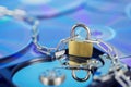 Data security, information protection and personal information defense. Padlock on hard drive disk at CD disk background. Concept Royalty Free Stock Photo