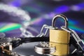 Data security, information protection and personal information defense. Padlock on hard drive disk at CD disk background. Concept Royalty Free Stock Photo