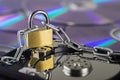 Data security, information protection and personal information defense. Padlock on hard drive disk at CD disk background. Concept Royalty Free Stock Photo