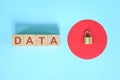 Data security and privacy protection concept. Data text on wooden blocks with metal padlock.