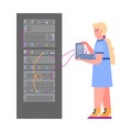 Data server rack technician holding laptop connected to hardware system