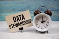 Data Stewardship text written on paper card with alarm clock on wooden background Royalty Free Stock Photo