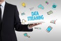 Data Streaming concept with young man holding a tablet computer Royalty Free Stock Photo