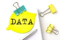 DATA text on yellow sticker on notebook with pen