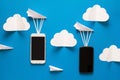 Data transfer concept. Message passing. Two mobile smartphones and paper airplanes