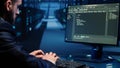Database admin checking mainframe system on computer