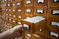 Database cabinet and human hand opens card drawer Royalty Free Stock Photo