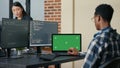 Database designer writing code using laptop with green screen chroma key mockup sitting at desk
