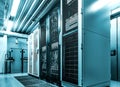 Datacenter server racks with network computers in neon blue toning. Room with several of mainframe hardware and supercomputers in