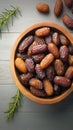 Date display Top view of dates in a wooden bowl