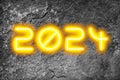 The date 2024 in glowing numbers on a textured background