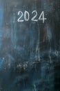 2024 date handwritten in a chalk writing text script on a wooden black chalkboard
